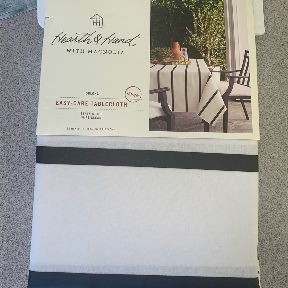 New in package. Hearth& Hand with Magnolia Easy Care Table Cloth 60”x 84”